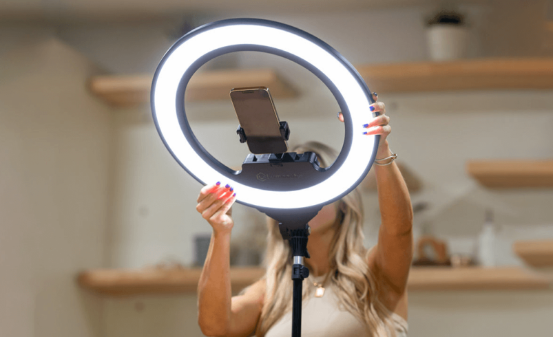 Beauty content creator filming step-by-step tutorial using ring light and phone at home