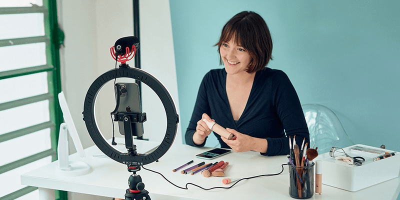 Woman applying lipstick on camera during a beauty step-by-step tutorial